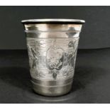 A white metal chased and monogrammed Vodka cup with marks to bottom (see images) 0.95oz, ht 5.5cm