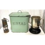 A miner's safety lamp; a green enamel bread bin; a 19th century silver plated trophy cup