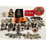 A selection of metal and cloth military and other badges and buttons