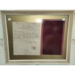 A framed piece of silk velvet with letter confirming it as part of the 'Royal Silk Velvet' for