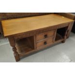 A Jacobean style oak 2 tier occasional table with central drawers