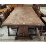 An oak reproduction dining table, refectory style with stretcher