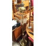 A Victorian standard oil lamp, turned brass in the Art Nouveau style on circular base and triple