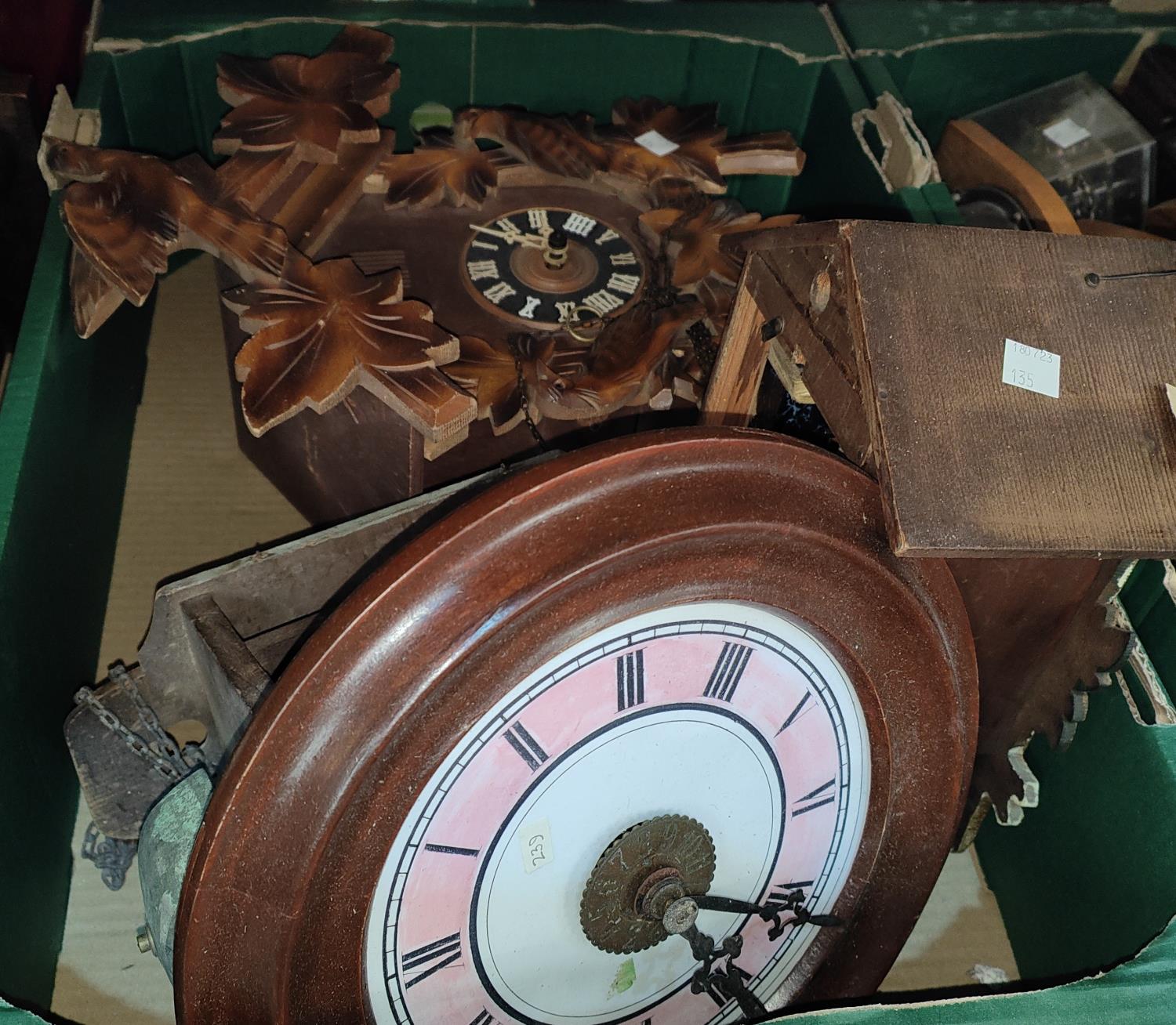 A 19th century circular dial "Postman's Alarm" wall clock; 2 Black Forest Cuckoo clocks