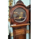 A late 18th century figured mahogany long case clock case with arch top hood and circular glass