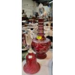 A CRANBERRY glass bell, 23cm and a cut red flash glass decanter, 40cm