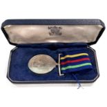 A Civil Defence Long Service medal awarded to William H Johnson, in original box
