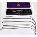 An unusual cased set of white metal medical funnels and silver antique catheter tubes, Down Bros,