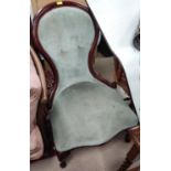 A spoon back nursing chair with sage upholstery