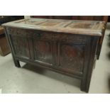 A late 17th/early 18th century blanket box, oak framed with hinged lid and carved front panels,