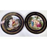A pair of Vienna Polychrome plates with classical figures in landscapes, blue and gilt borders,