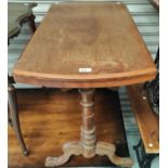 An early 20th century mahogany table with turned legs and supports; a rattan footstool and a black