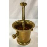 A 19th century large brass pestle and mortar