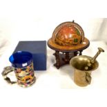 An antique brass pestle and mortar, an Italian globe and a musical tankard, boxed