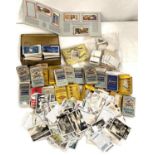 A selection of cigarette cards in packs and loose