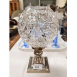 A Waterford crystal cut glass light bowl on a square silver plated candle stick.