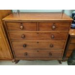A mahogany chest of three long two short drawers with ogee feet bun handles and wooden escutcheons