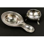 A white metal tea strainer stamped 835; a hallmarked silver salt cellar, total 2.4oz