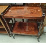 A mahogany reproduction tea trolley with 2 tiers; an Edwardian mahogany Sutherland table