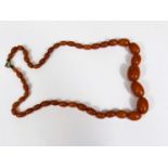 A vintage Amber coloured Bakelite necklace, graduating beads, internal swirl, largest bead 2.5cm,