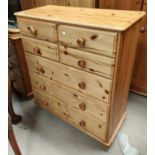 A modern pine chest of 3 long and 4 short drawers; a 3-height bedside cabinet