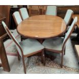 A mid 20th century teak G-Plan oval extending dining table 'Whale Tale' supports six high back G-