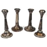 A pair of dwarf hallmarked silver candlesticks on weighted bases, Birmingham 1955 ht. 13cm; a pair
