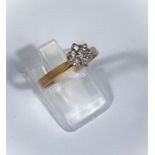A 9ct gold ring with diamond flower head, 7 stones, 1.9gm