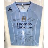 An MCFC shirt 'Thomas Cook.com' with multiple signatures