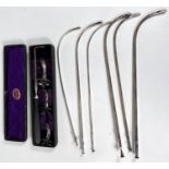 An unusual cased set of white metal medical funnels and silver antique catheter tubes, Down Bros,