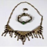 A Middle Eastern white necklace with three front triangular panels with drops and set with oval