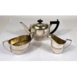 A hallmarked silver bachelors 3 piece tea set in the Georgian oval fluted style