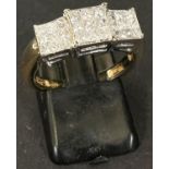 A modern 18 carat hallmarked gold ring with 27 square diamonds in 3 square settings, size N/O, 6.5gm