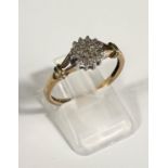A 9ct gold ring with diamond flower head, 19 stones, 1.8gm