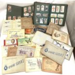 A selection of cigarette cards in albums