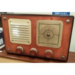 A 1940's/1950's mahogany cased radio with red metallic tuners and plastic turning dial.