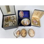 A selection of cameo brooches, ceramic and others,; a selection of clip on earrings.