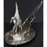 A silver plated swan shaped bandy warmer with central light.