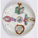 A Chinese saucer with polychrome decoration of .... and gifts with text, dia. 13.5cm