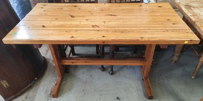 A pine refectory table with plank top and peg stretcher below, 137 x 69cm
