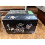 A Japanese Meiji period lacquer tea caddy inlaid with mother of pearl, building to top and flowers