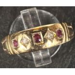 An 18 carat hallmarked gold gypsy ring set 3 small rubies and 2 diamonds, size N, 3gm