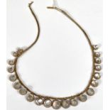 A yellow metal fringe necklace of woven gauze work set 21 graduating circular moonstone effect