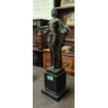 An Art Deco style bronze figure of a young woman with outstretched arms and flowing robe, with