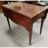 A 19th century mahogany Pembroke table in the Sheraton style with serpentine leaves and frieze