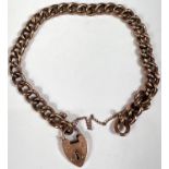 A yellow metal curb chain bracelet with heart lock, both stamped '9ct', 9.75gm