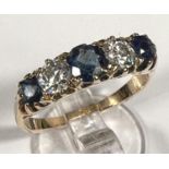 A Victorian style yellow metal ring set 3 alternating sapphires and 2 diamonds, stamped '18ct',