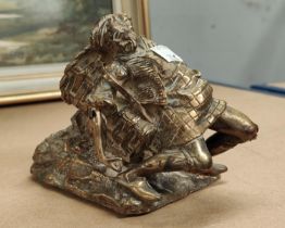 An unusual gilded bronze spill vase in the form of a figure, a drunken basket carrier slumping