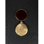 A George III half guinea dated 1803 in gold and bloodstone locket (tests as 14ct), 7.6gm