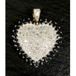 A 14k yellow and white gold heart shaped pendant encrusted with diamonds surrounded by sapphires